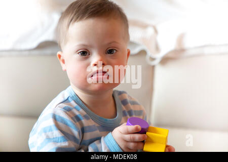 Portrait of cute baby boy with Down syndrome Stock Photo