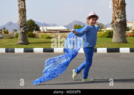 little girl with a blue scarf Stock Photo