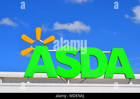 A green Asda supermarket sign against a clear blue sky Stock Photo - Alamy