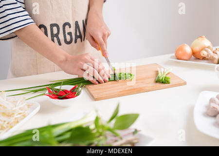 Female chef prepare traditional Vietnamese soup Pho bo with herbs, meat, rice noodles Stock Photo