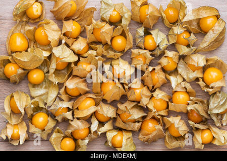 Physalis peruviana. Cape gooseberry fruit on a wooden board Stock Photo