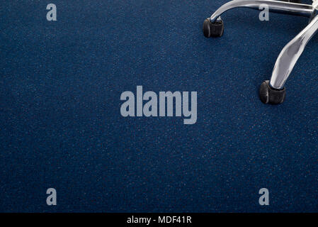 Office chair on blue carpet Stock Photo