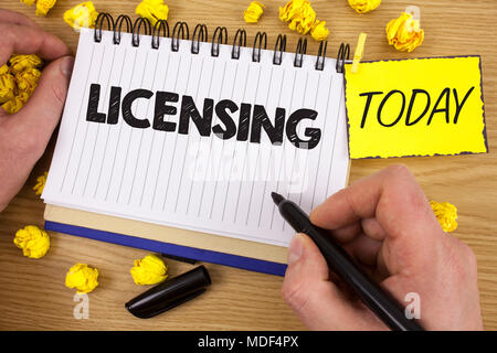 Word writing text Licensing. Business concept for Grant a license Legally permit the use of something Allow activity written by Man Notepad holding  M Stock Photo