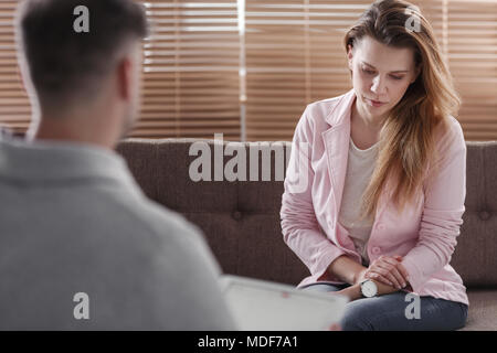 Depressed woman talking to an advisor about a divorce Stock Photo