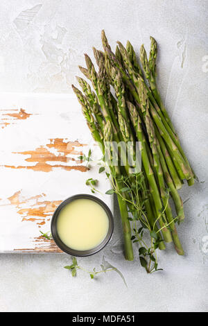 fresh green asparagus and old white wooden board Stock Photo