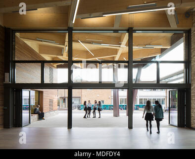 View from inside building looking out to the canopy. Stephen Perse Foundation Learning and Sports building, Cambridge, United Kingdom. Architect: Chad Stock Photo