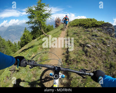 Two people mountain biking in Dolomites,Val D'Aosta,Italy Stock Photo