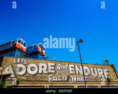 Lets Adore and Endure landmark in London's Great Eastern Street Shoreditch Graffiti  by American artist Steve Powers, the train carriages now studios Stock Photo