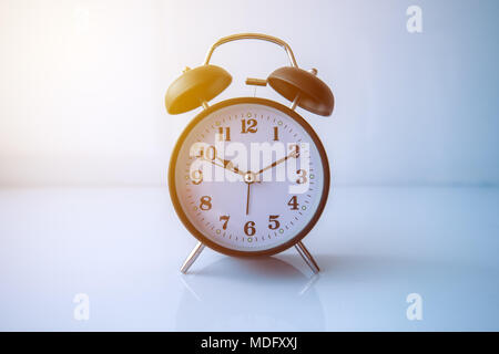 Retro style analog black alarm clock shows 10 hours and ten minutes Stock Photo