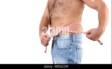 Overweight man with tape measure around waist . Man fat belly in jeans. Stock Photo