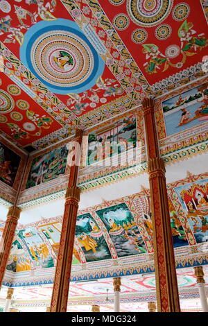 Intricate paintings on the ceiling of a temple on the grounds of Pha That Luang depicting Buddha's life. Vientiane, Laos, 2015. Stock Photo