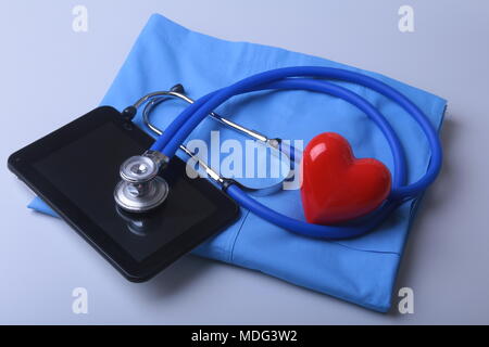 Premium Photo  Doctor coat with medical stethoscope and red heart on the  desk