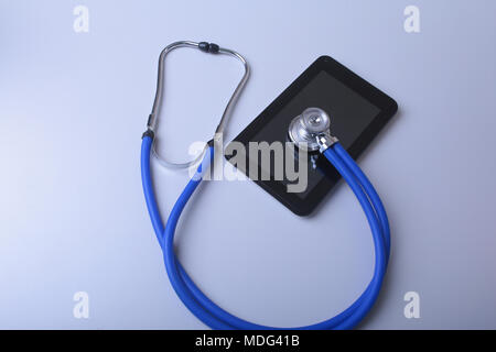 Medical equipment: blue stethoscope and tablet on white background Stock Photo