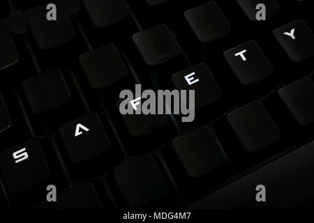 Safety word on keyboard with rearranged letters, backlit keys Stock Photo