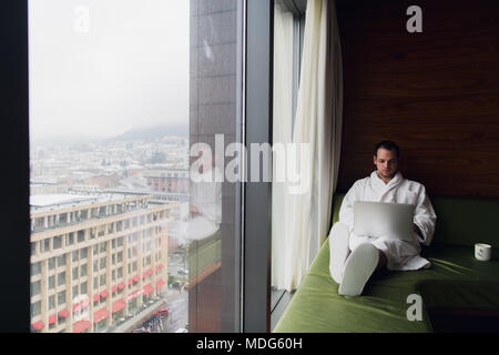 Young man freelancer working from home on a laptop Stock Photo