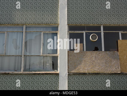 Broken windows and boarded up windows in disused fire station in bury lancashire uk Stock Photo