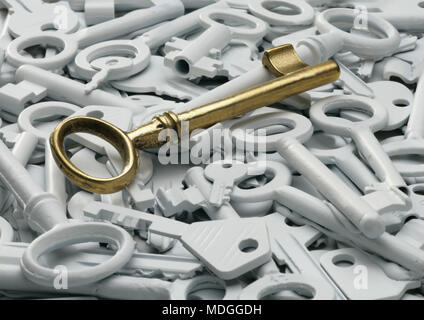Golden vintage key over a many white keys  Stock Photo