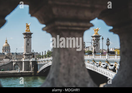 Bridge of Alexander III (Pont Alexandre III) framed by pillars from across the Seine River Stock Photo