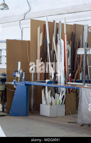 Furniture accessories. Colorful wooden floor for home renovation. Manufacture of skirting boards in a furniture factory. Stock Photo