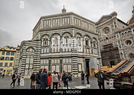 FLORENCE, ITALY -  NOVEMBER 7, 2017: people in duomo square the Baptisterium and Santa Maria del Fiore Cathedral in the background Stock Photo