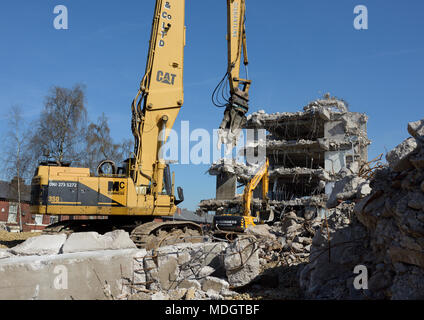 Caterpillar 350L high reach demolition excavator with concrete crusher attachment and partly demolished concrete building on demolition site,  bury uk Stock Photo