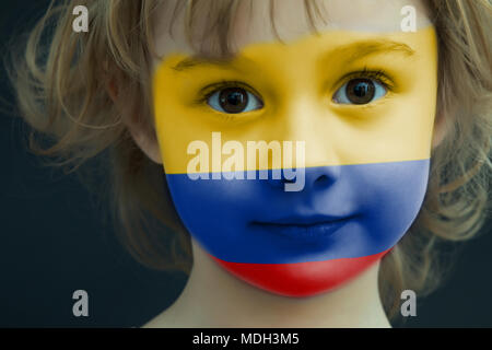 Child with a painted flag of Columbia Stock Photo