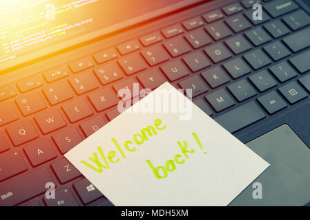 Welcome back message concept written post it on laptop keyboard Stock Photo