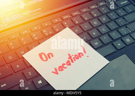 On vacantion message concept written post it on laptop keyboard Stock Photo