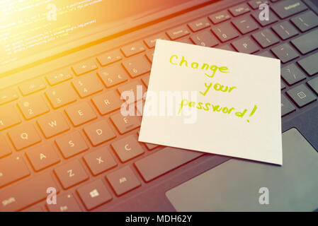 Change your password message concept written post it on laptop keyboard Stock Photo