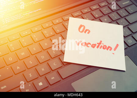 On vacantion message concept written post it on laptop keyboard Stock Photo