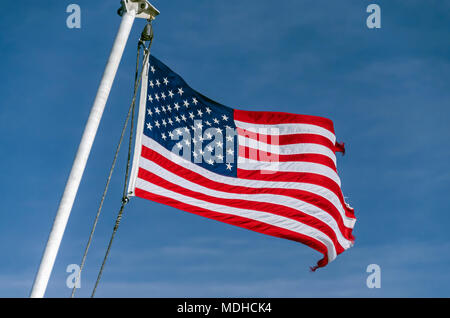 American flag flying at the stern of the Alaska Marine Highway System ferry MV LeConte between Juneau and Gustavus, Alaska Stock Photo