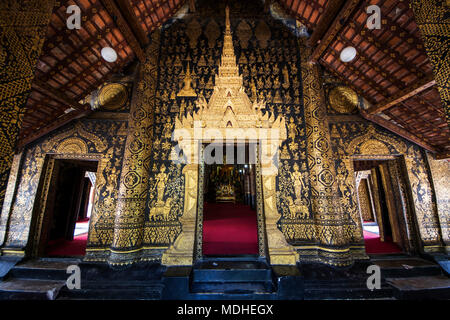 Black and gold stencilled columns on the portico of the sim (congregation hall) of Wat Xieng Thong; Luang Prabang, Laos Stock Photo