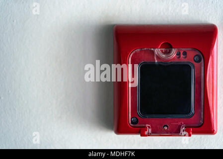 Close up of fire alarm switch in red box on wall Stock Photo