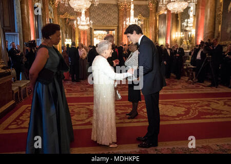 Queen Elizabeth II greets Canada's Prime Minister Justin Trudeau in the Blue Drawing Room at Buckingham Palace in London as she hosts a dinner during the Commonwealth Heads of Government Meeting.