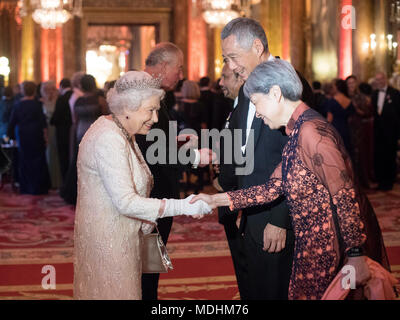 Queen Elizabeth II greets Hsien Loong, Prime Minister of Singapore, and his wife Ho Ching, in the Blue Drawing Room at Buckingham Palace in London as she hosts a dinner during the Commonwealth Heads of Government Meeting.