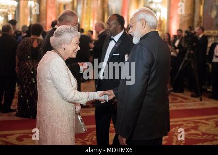Queen Elizabeth II greets Narendra Modi, Prime Minister of India, in the Blue Drawing Room at Buckingham Palace in London as she hosts a dinner during the Commonwealth Heads of Government Meeting. Stock Photo