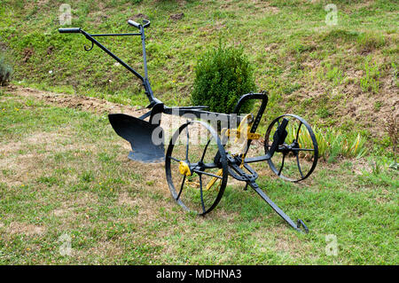 old horse plow set on the grass Stock Photo