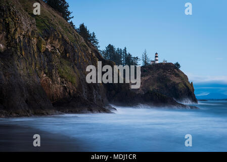 Surf washes the shore at dusk on the Washington Coast; Ilwaco, Washington, United States of America Stock Photo