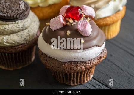 Chocolate and marshmallow decorated cup cake with cherry on top Stock Photo