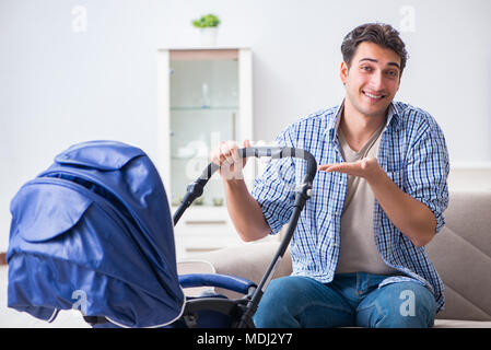 Young father looking after newborn baby at home Stock Photo