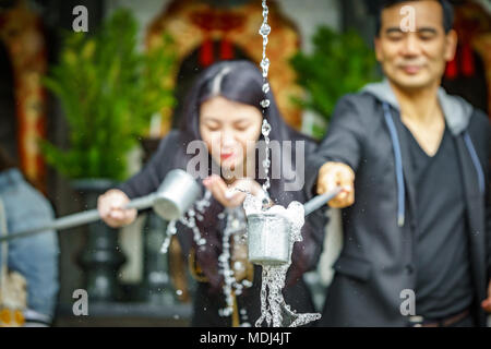 KYOTO- JUNE 8: Unidentified tourist take water for purification at the entrance of Japanese temple in Kyoto on June 8, 2015 Stock Photo