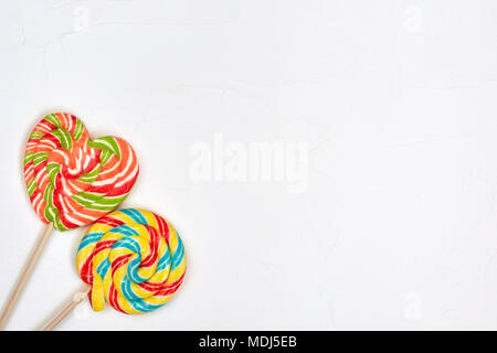 Swirl rainbow lollipop candy on white background, copyspace Stock Photo