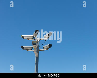 Image with various video surveillance cameras. Six cctv security cameras on the street pylon. Security cameras mounting on the high top position Stock Photo