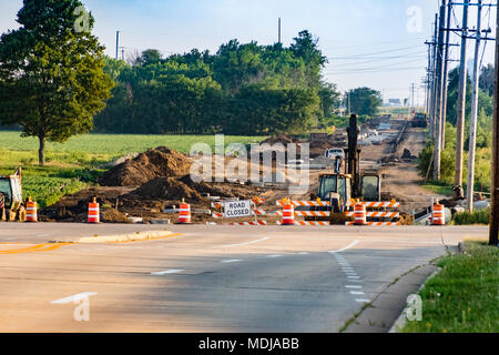 the road work continues on this long closed street Stock Photo