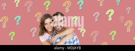 Happy couple with colorful funky question marks Stock Photo