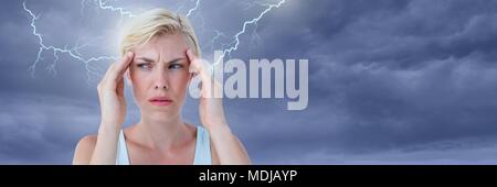 Lightning strikes and stressed woman with headache holding head Stock Photo