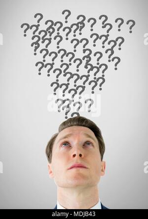Man with grey question marks emerging from head Stock Photo