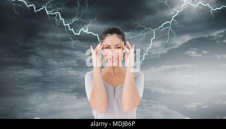 Lightning strikes and stressed woman with headache holding head Stock Photo