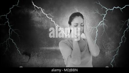 Lightning strikes and stressed woman with headache holding head Stock Photo