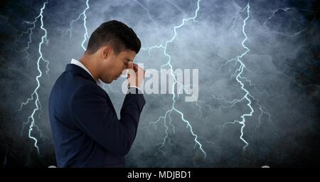 Lightning strikes and stressed man with headache holding head Stock Photo